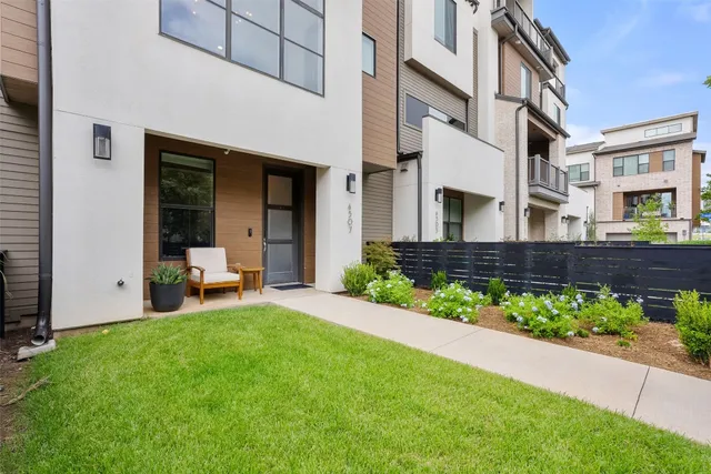 a view of a house with a patio and a garden