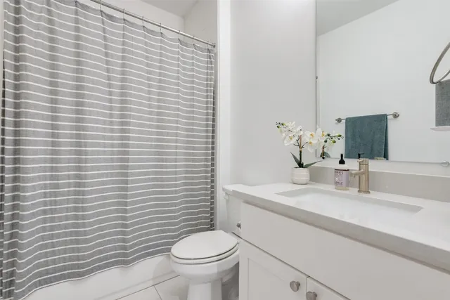 a bathroom with a sink a toilet and mirror