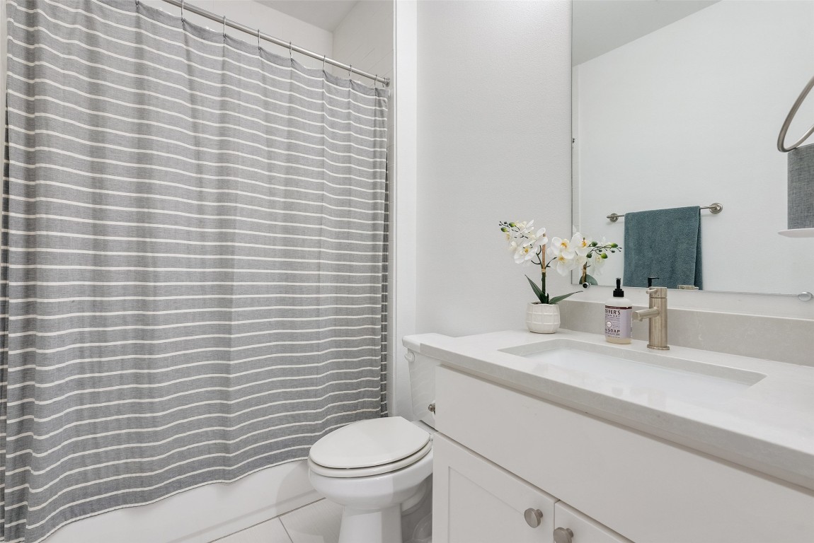 4507 Unity Circle Austin, TX 78731 - Photo 8 of 37 Full bath featuring vanity, shower / tub combo with curtain, and tile patterned floors