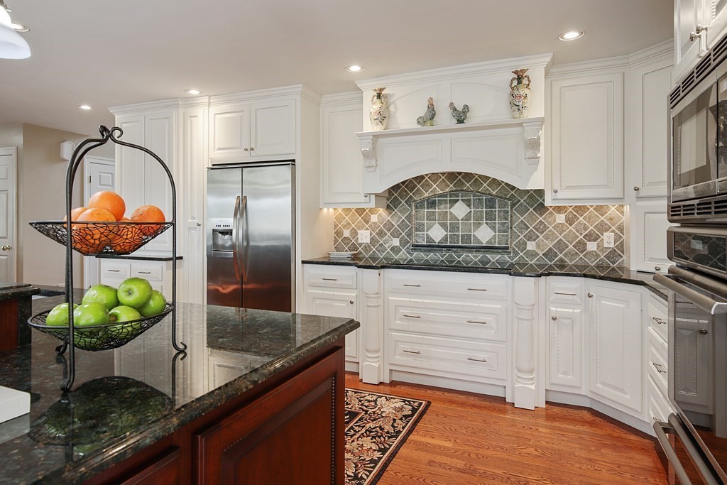 31 Draper Road Dover, MA 02030 - Photo 16 of 41 a kitchen with stainless steel appliances granite countertop a stove a sink and a microwave