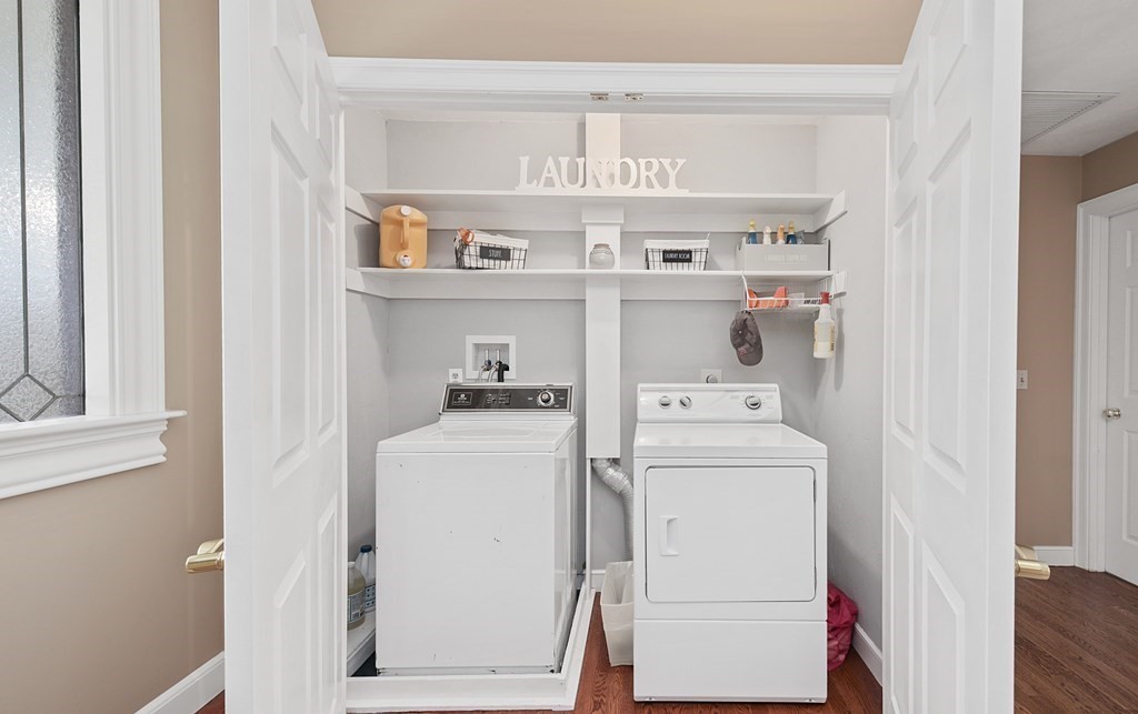 31 Draper Road Dover, MA 02030 - Photo 18 of 41 a view of washer and dryer with kitchen in the background