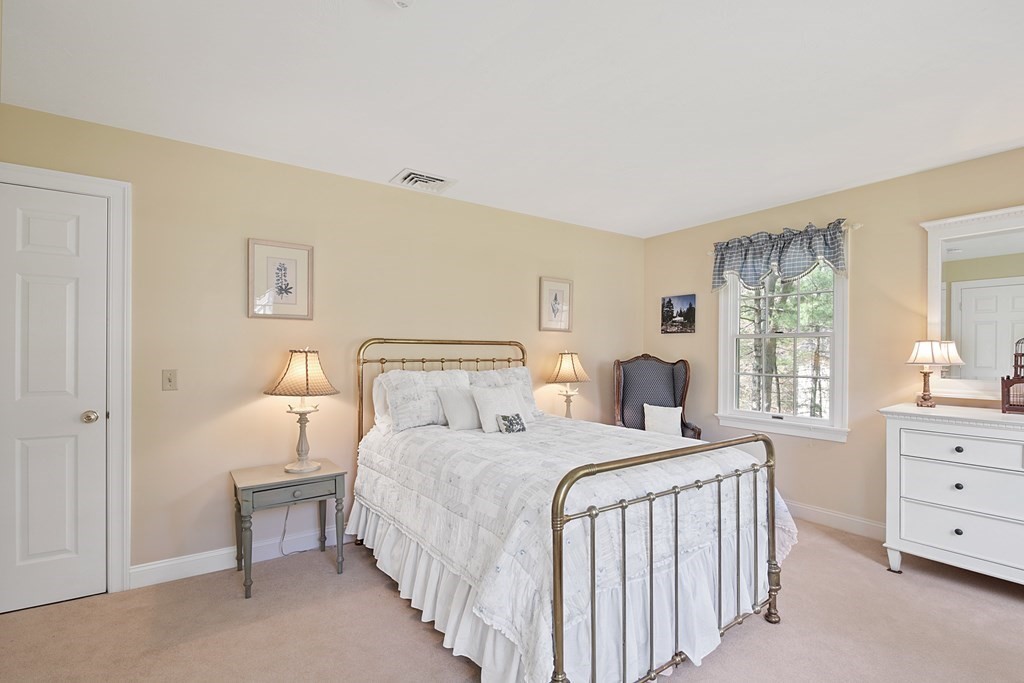 31 Draper Road Dover, MA 02030 - Photo 20 of 41 a bedroom with a bed a lamp and a window