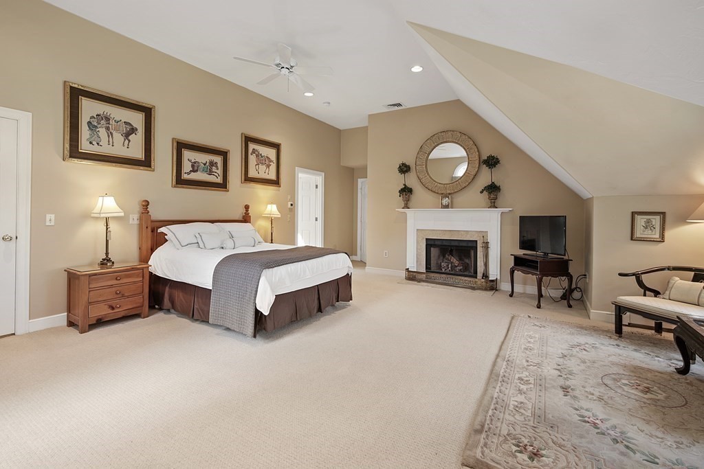 31 Draper Road Dover, MA 02030 - Photo 23 of 41 a spacious bedroom with a bed a fireplace and a fish tank