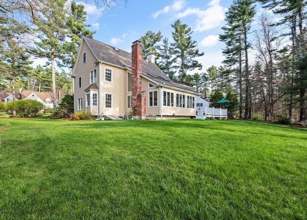 31 Draper Road Dover, MA 02030 - Photo 33 of 41 a front view of a house with a garden and trees