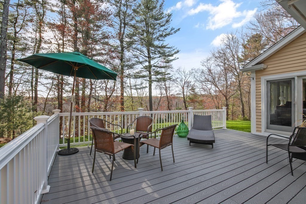 31 Draper Road Dover, MA 02030 - Photo 36 of 41 a view of a deck with furniture and barbeque grill with wooden floor and fence