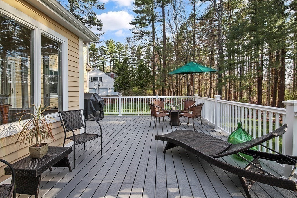 31 Draper Road Dover, MA 02030 - Photo 37 of 41 a view of a roof deck with table and chairs and wooden floor