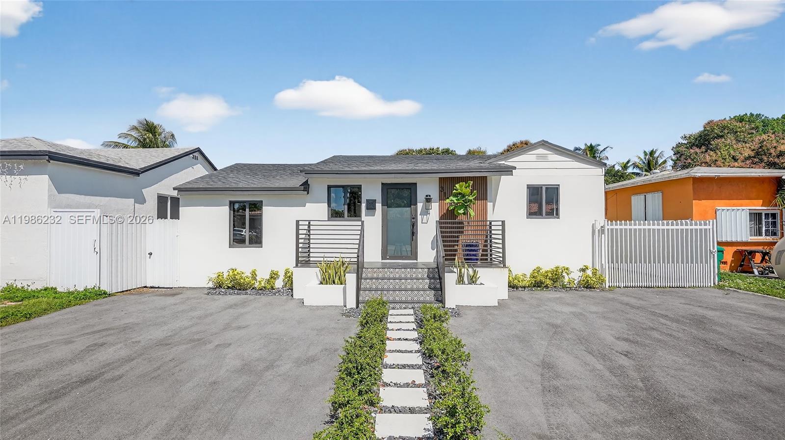 3135 Southwest 7th Street Miami, FL 33135 - Photo 1 of 20 a front view of a house with a garden and patio