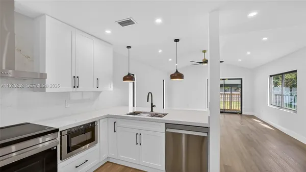 a kitchen with a sink stainless steel appliances and cabinets