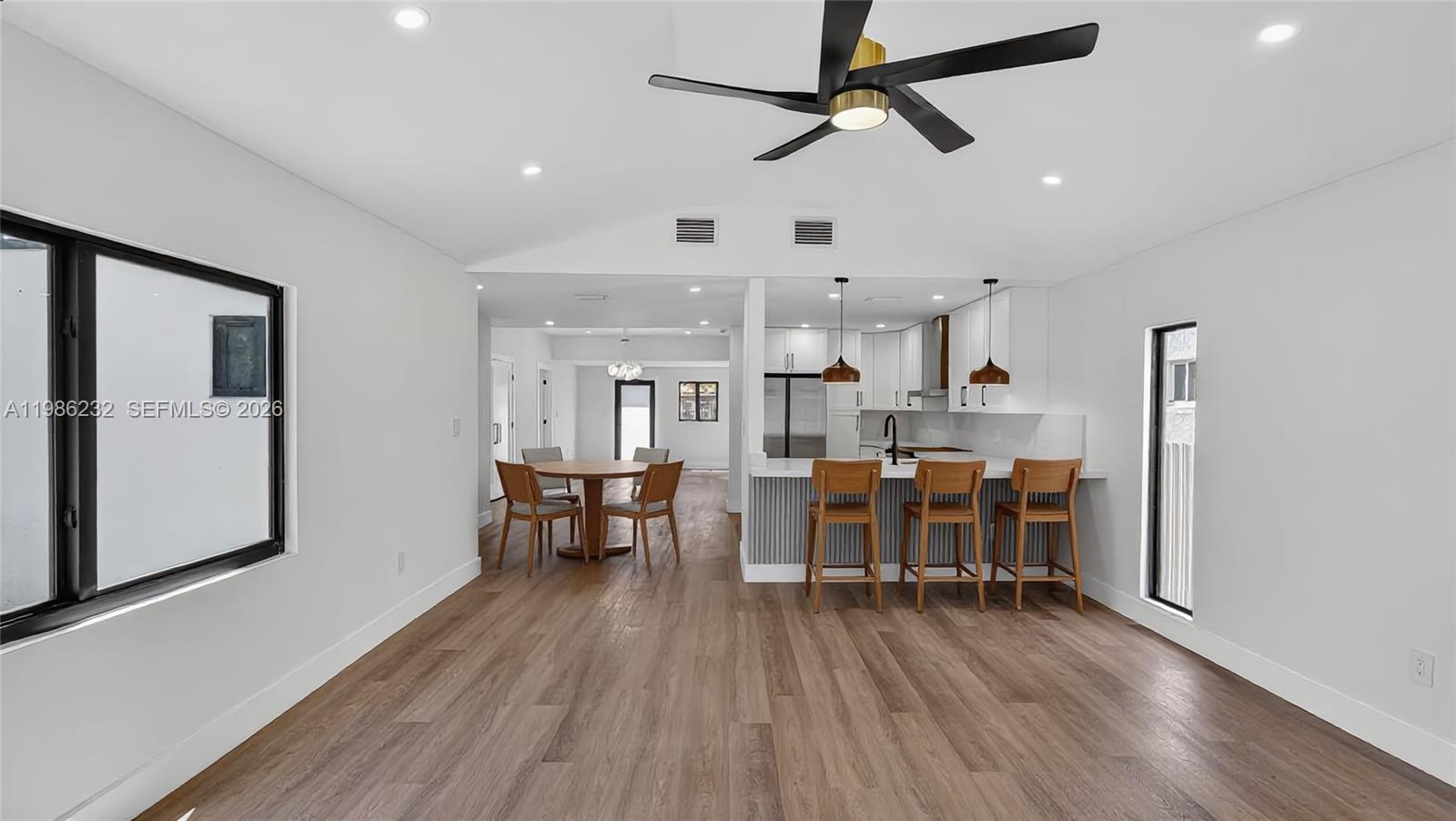 3135 Southwest 7th Street Miami, FL 33135 - Photo 15 of 20 a view of a dining room with furniture window and wooden floor