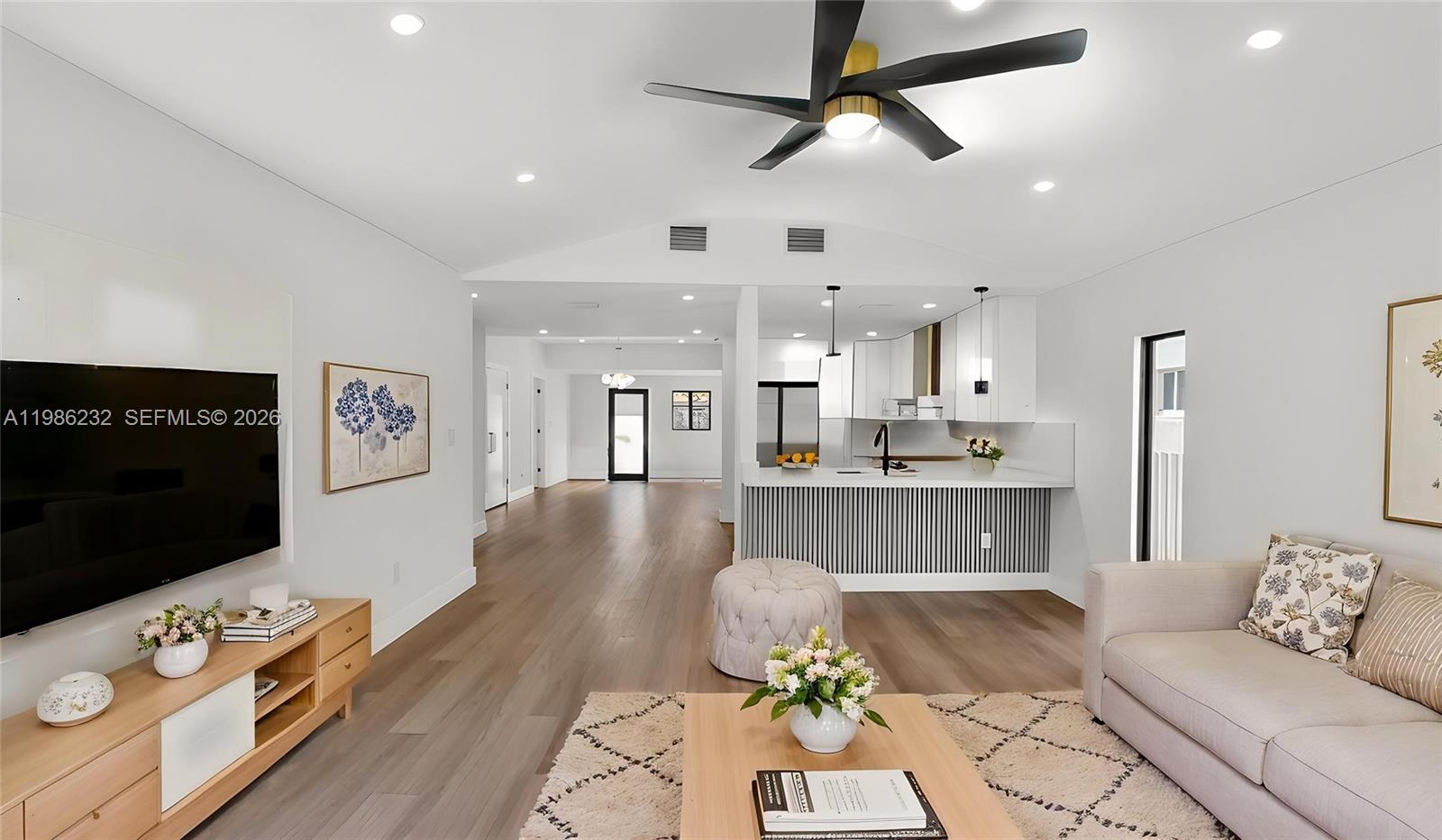 3135 Southwest 7th Street Miami, FL 33135 - Photo 19 of 20 a living room with stainless steel appliances kitchen island furniture and a flat screen tv