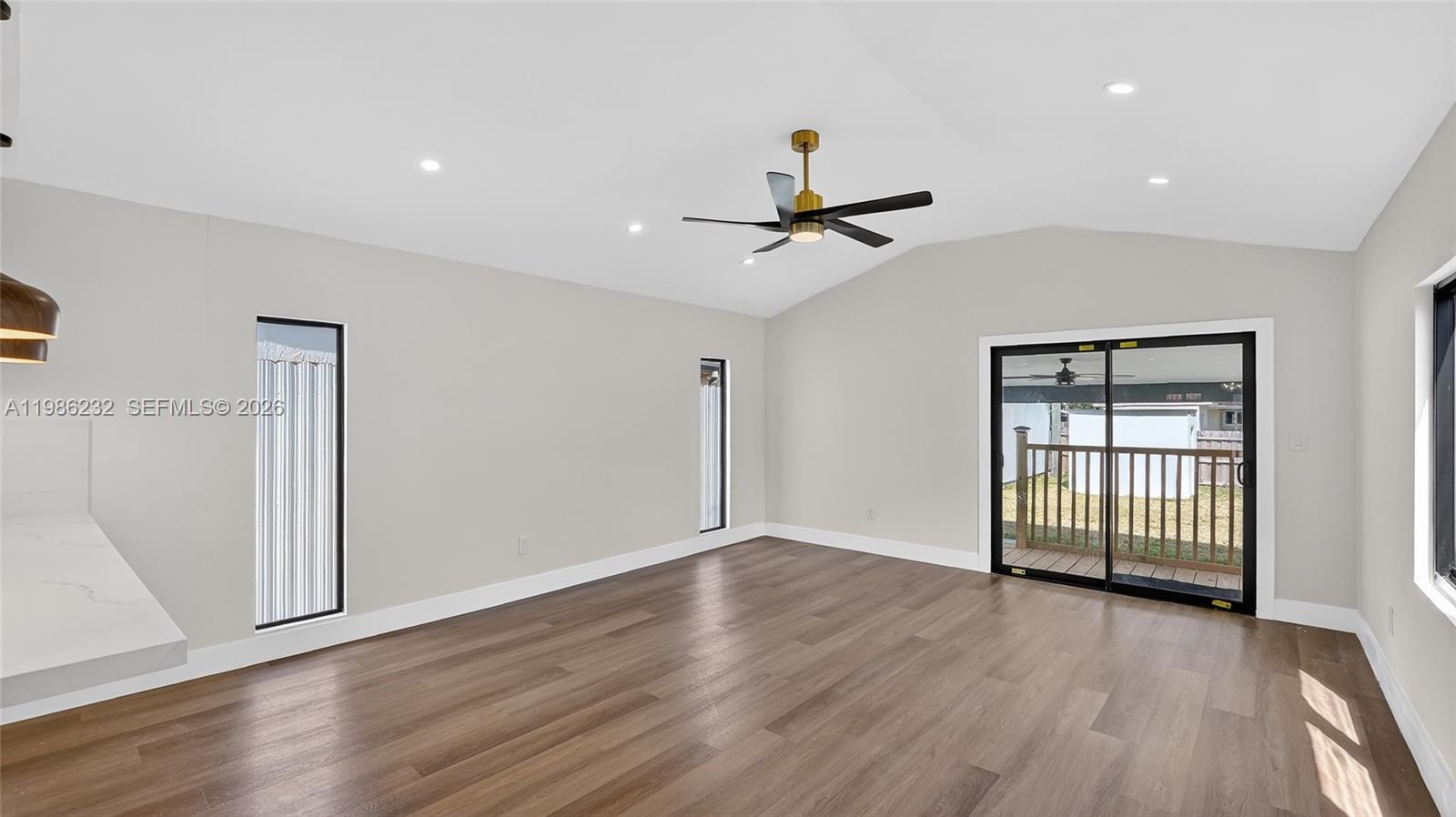 3135 Southwest 7th Street Miami, FL 33135 - Photo 20 of 20 a view of a livingroom with wooden floor and a ceiling fan