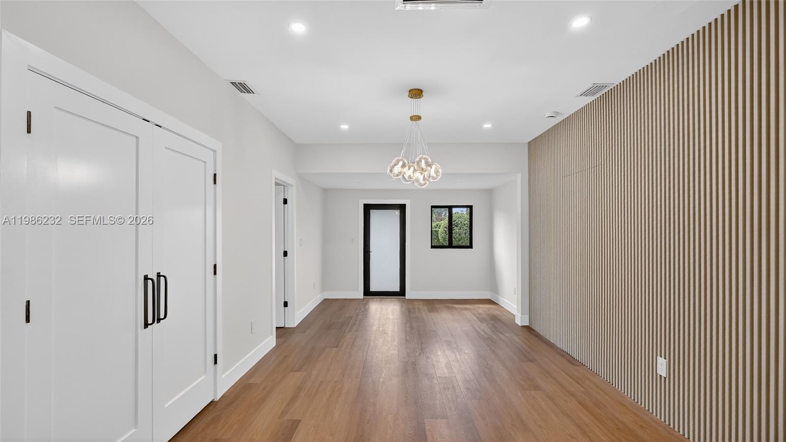 3135 Southwest 7th Street Miami, FL 33135 - Photo 3 of 20 a view of a hallway with wooden floor