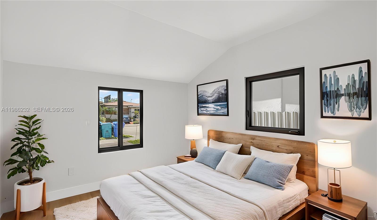 3135 Southwest 7th Street Miami, FL 33135 - Photo 6 of 20 a bedroom with a large bed and a potted plant