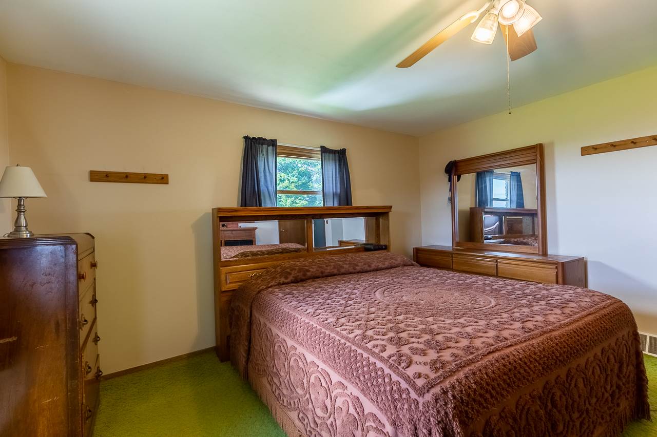 11218 Center Road Durand, IL 61024 - Photo 14 of 25 a bedroom with a bed and dresser