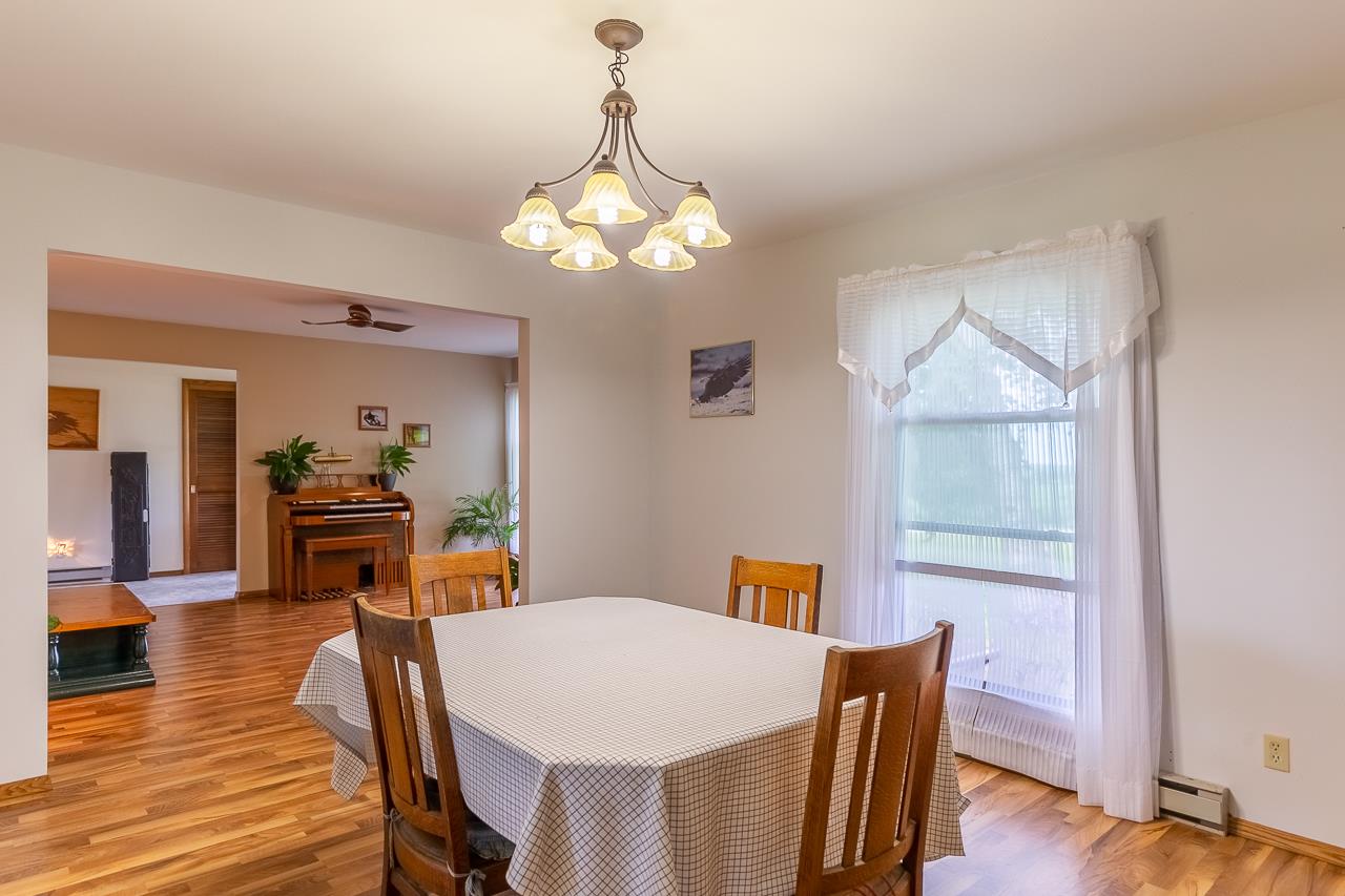 11218 Center Road Durand, IL 61024 - Photo 5 of 25 a view of a dining room with furniture wooden floor and chandelier