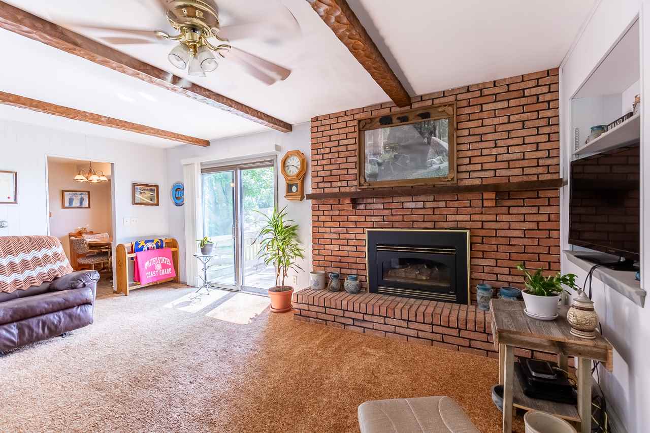 11218 Center Road Durand, IL 61024 - Photo 8 of 25 a living room with furniture and a fireplace