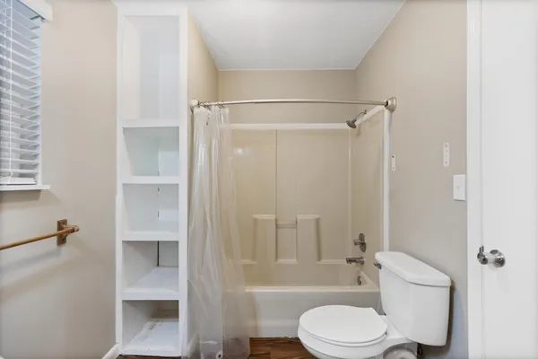 a bathroom with a toilet and shower
