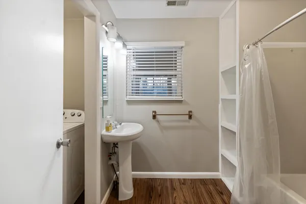 a bathroom with a sink a mirror and a shower