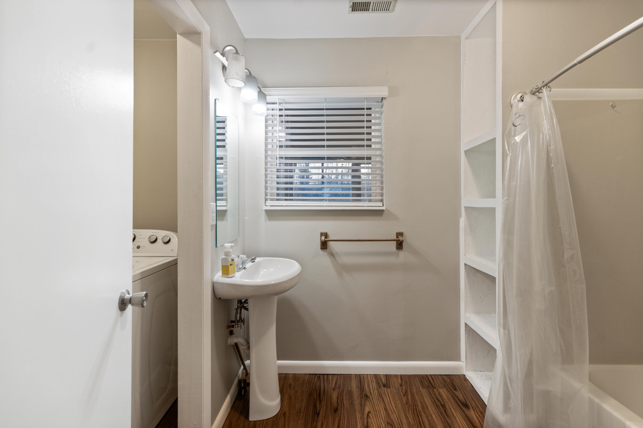 448 Apache Trail Northwest Cleveland, TN 37312 - Photo 16 of 38 a bathroom with a sink a mirror and a shower