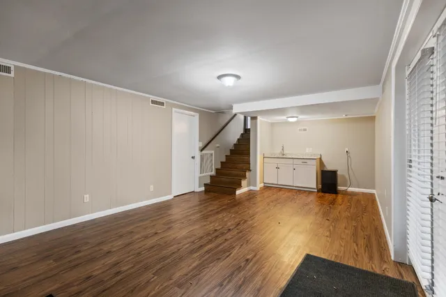 a view of a room with wooden floor and stairs