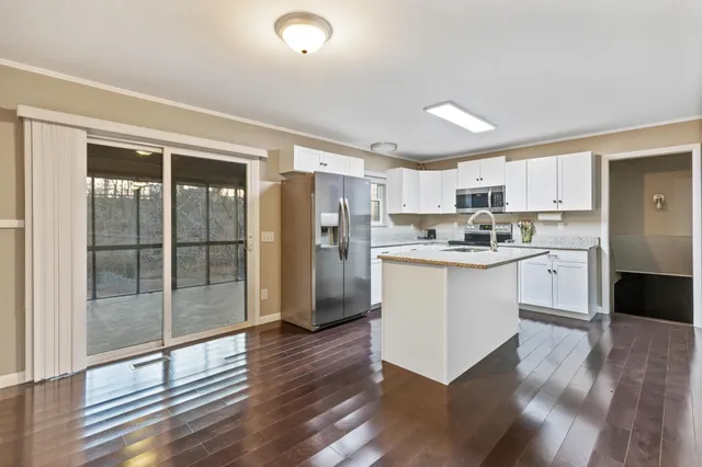 a kitchen with a refrigerator a sink and cabinets