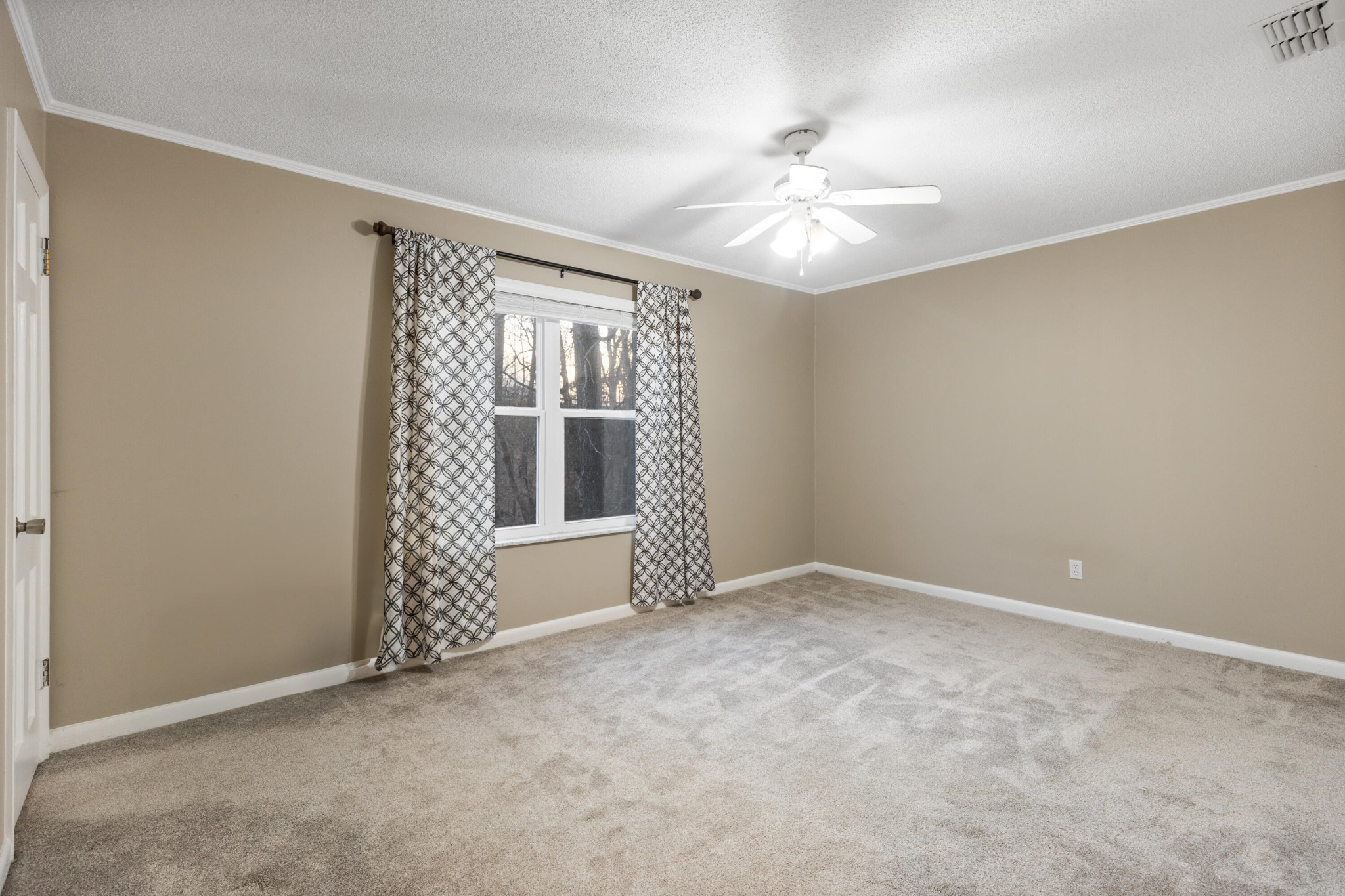 448 Apache Trail Northwest Cleveland, TN 37312 - Photo 10 of 38 an empty room with chandelier fan and windows