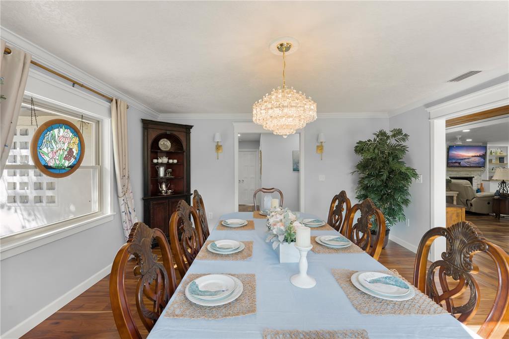 1209 Roxboro Road Longwood, FL 32750 - Photo 12 of 74 a view of a dining room with furniture a chandelier and wooden floor