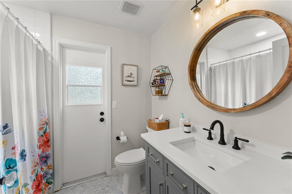 1209 Roxboro Road Longwood, FL 32750 - Photo 43 of 74 a bathroom with a sink a toilet and a mirror