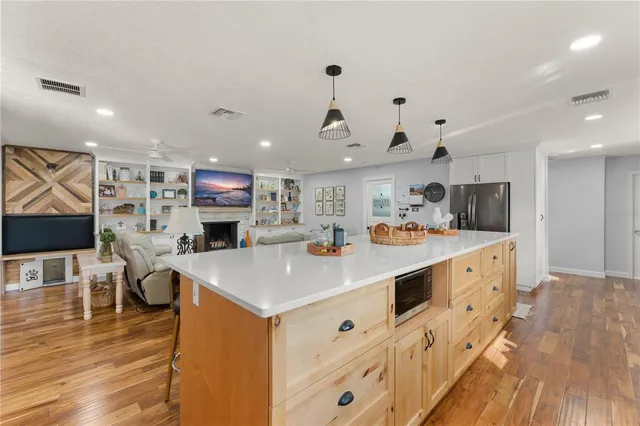 a view of a dining room with furniture a chandelier and wooden floor