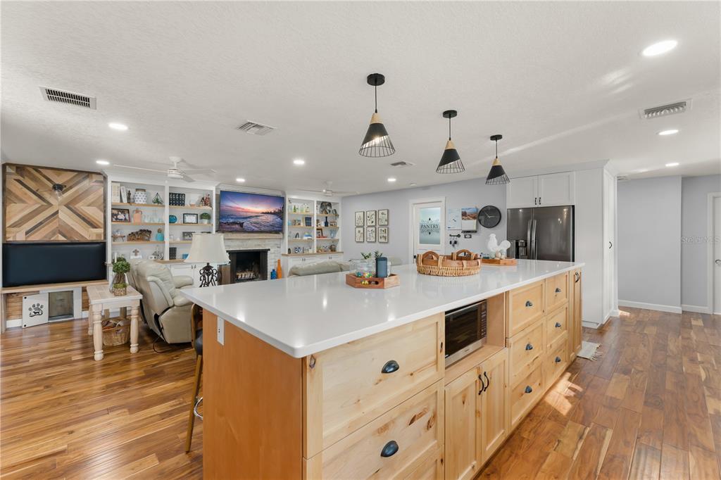 1209 Roxboro Road Longwood, FL 32750 - Photo 6 of 74 a large kitchen with stainless steel appliances kitchen island a large counter top space a sink and a wooden floor