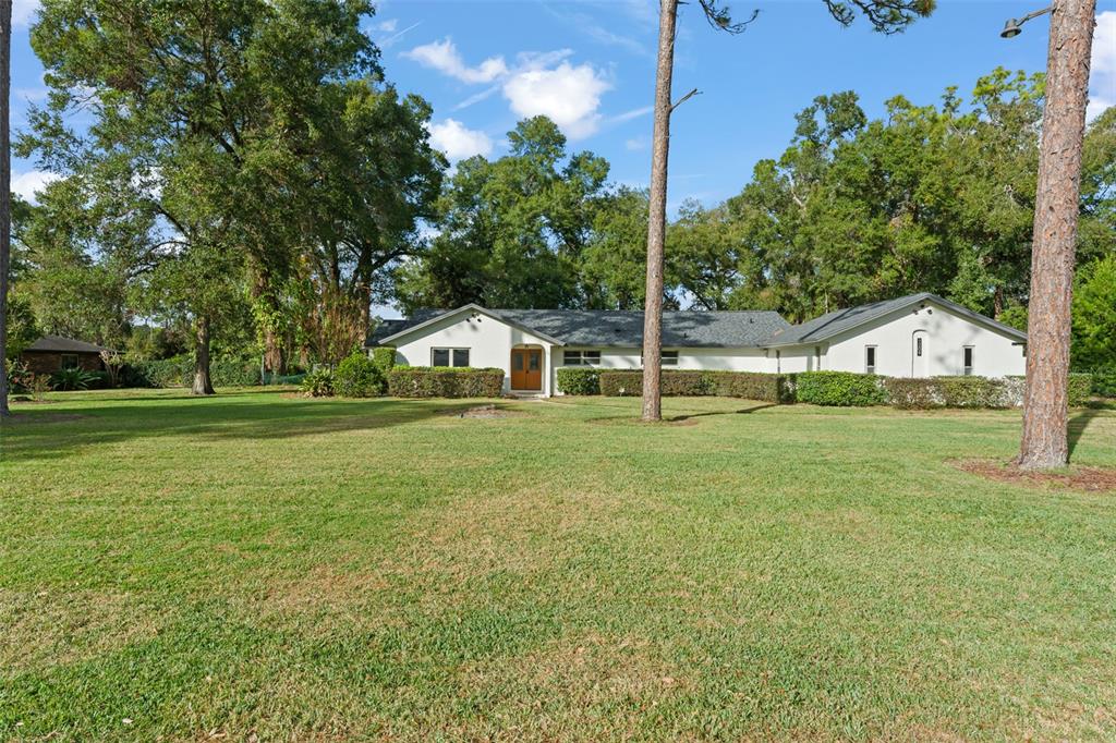 1209 Roxboro Road Longwood, FL 32750 - Photo 63 of 74 a view of house with garden and tall trees