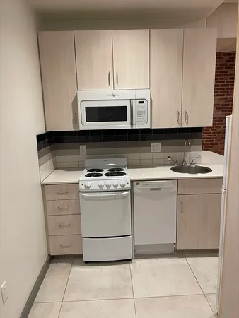 a kitchen with cabinets appliances and a sink