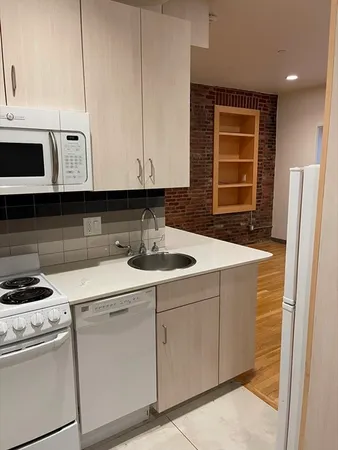a kitchen with a sink cabinets and appliances