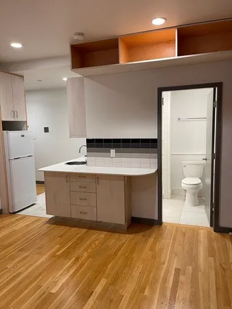 a spacious bathroom with a granite countertop sink a toilet and a vanity