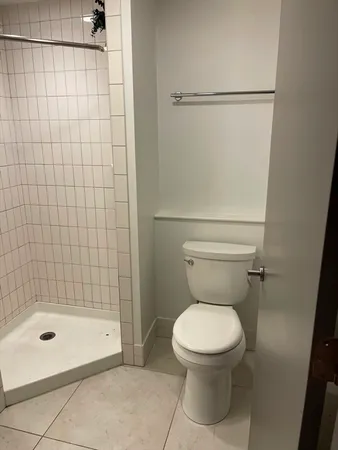 a bathroom with a toilet and a shower