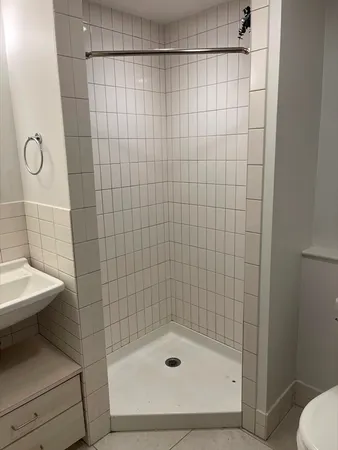 a bathroom with a shower and a toilet