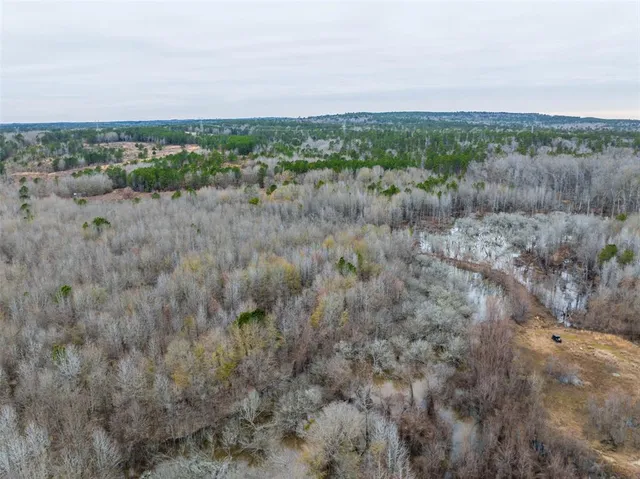 a view of a lake and green valley