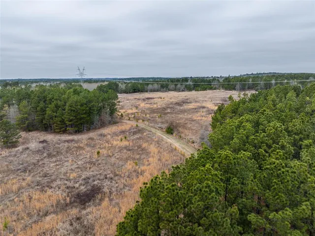 a view of a lake with beach in background