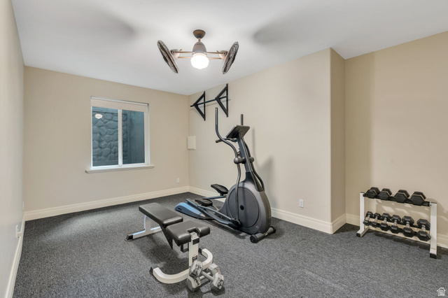 650 East Center Street Alpine, UT 84004 - Photo 27 of 38 Dedicated fitness room featuring dark textured flooring, a single window, and a ceiling fan with integrated lighting