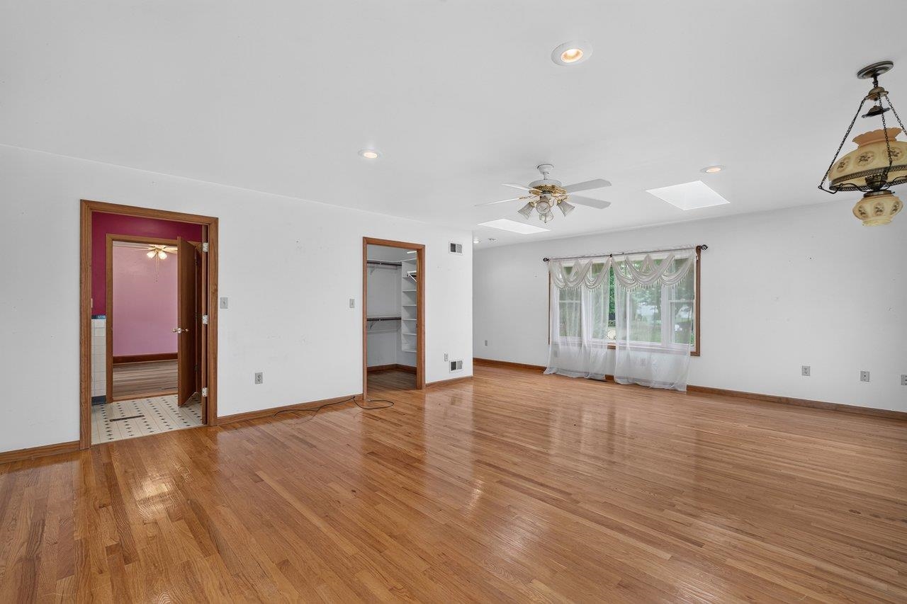 10402 Phillips Store Road Broadway, VA 22815 - Photo 26 of 68 a view of an empty room with a window and wooden floor
