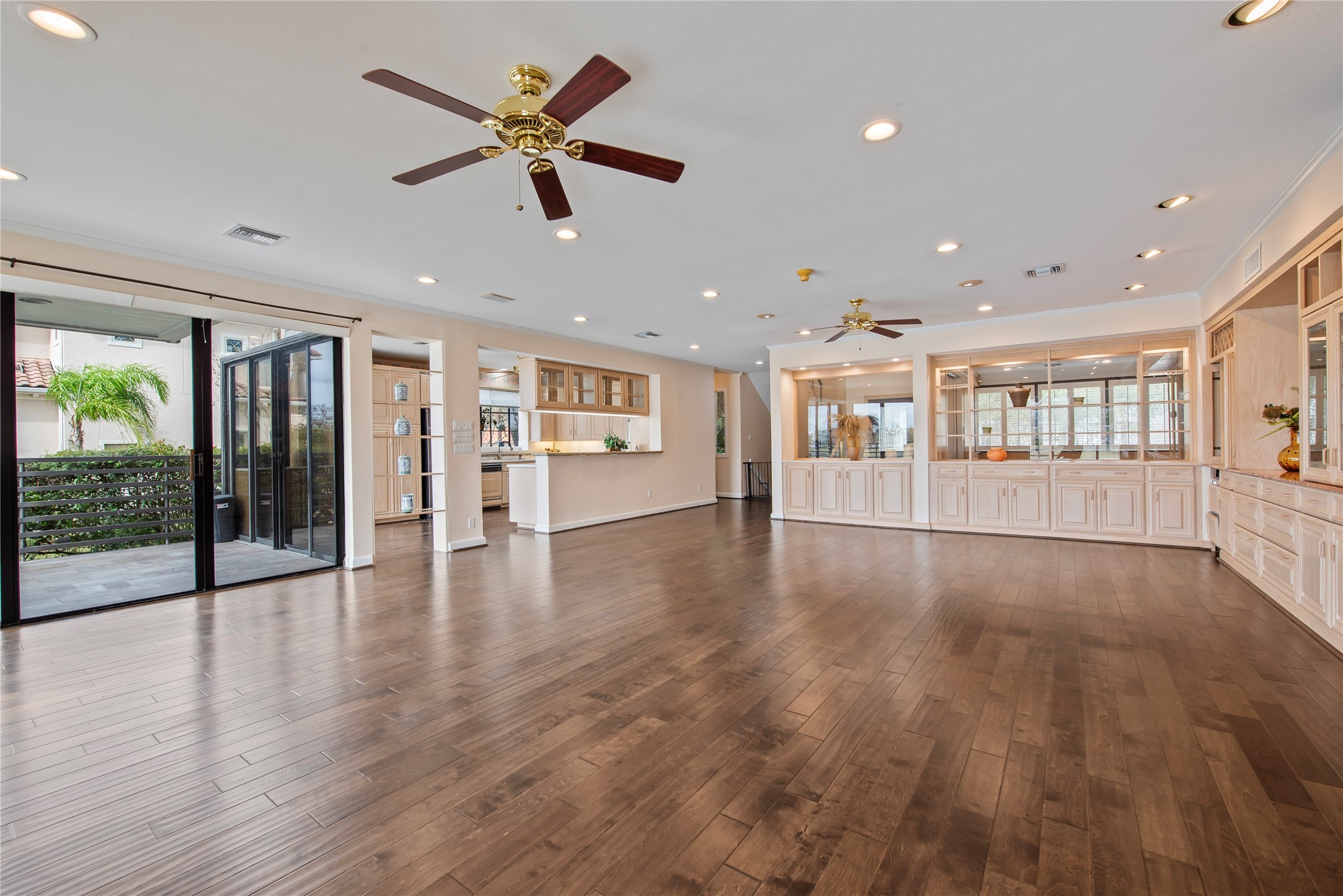 2037 Enterprise Avenue League City, TX 77573 - Photo 12 of 49 a view of an empty room with wooden floor and a kitchen