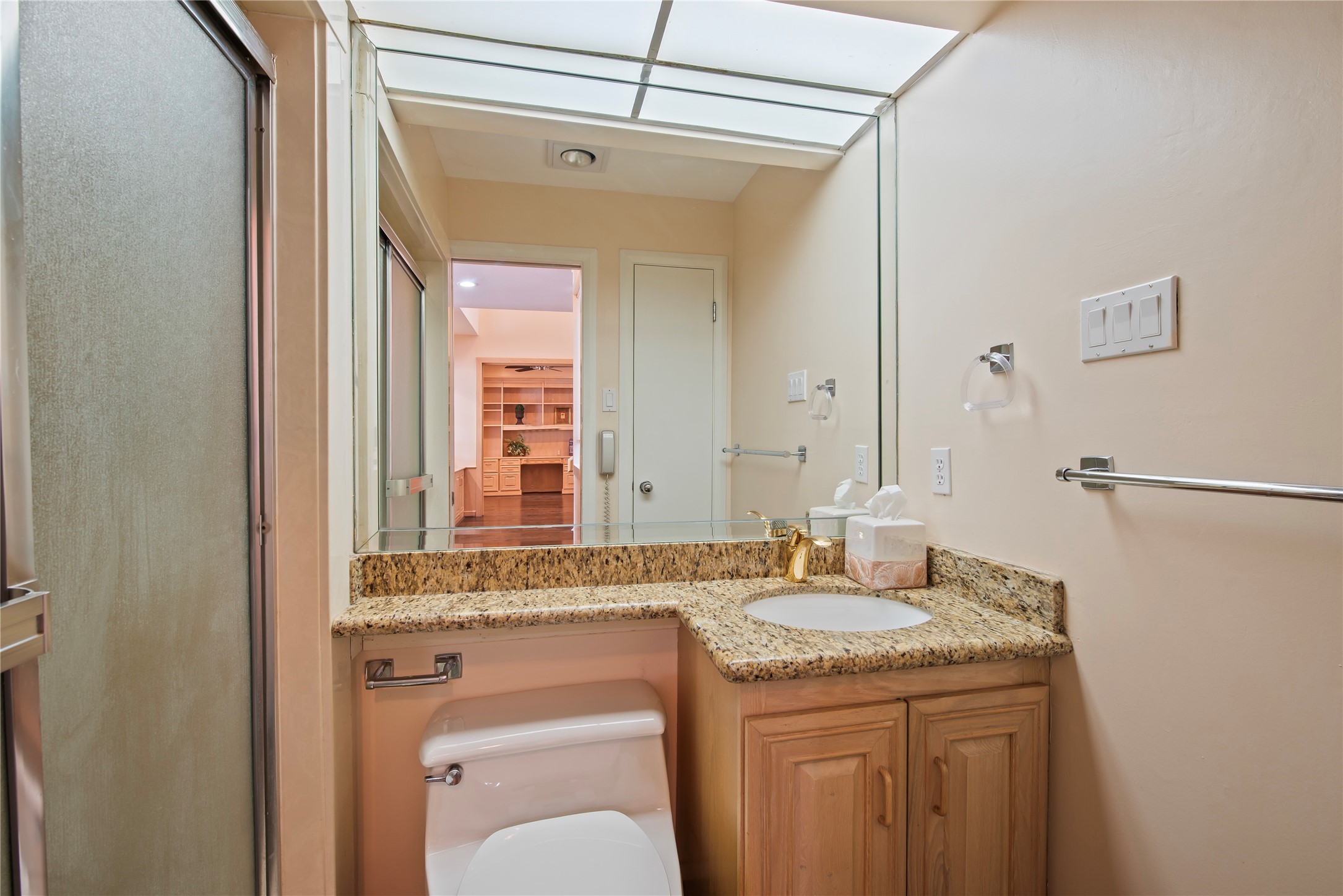 2037 Enterprise Avenue League City, TX 77573 - Photo 13 of 49 a bathroom with a granite countertop sink a toilet and a mirror