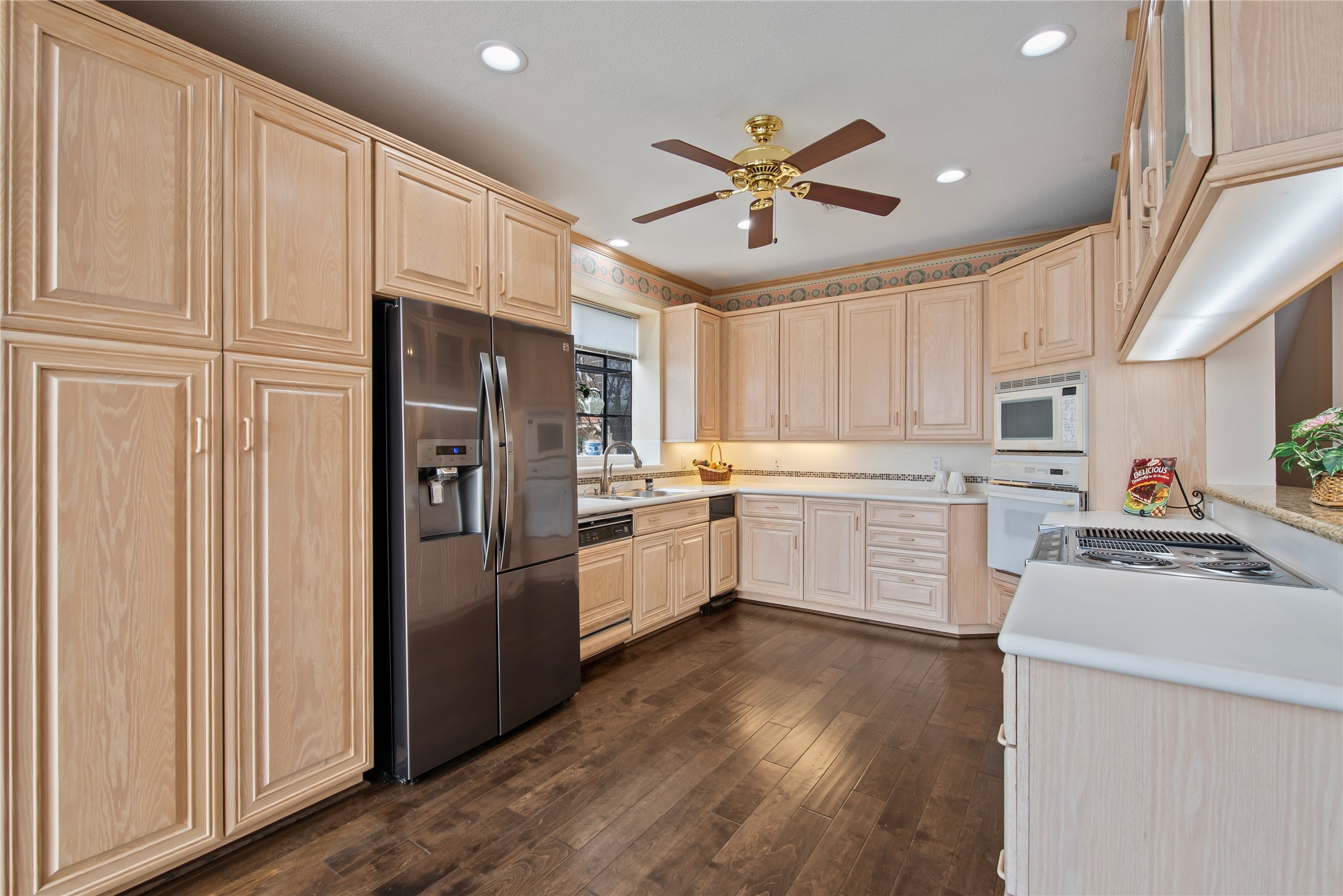 2037 Enterprise Avenue League City, TX 77573 - Photo 14 of 49 a kitchen with white cabinets and white appliances
