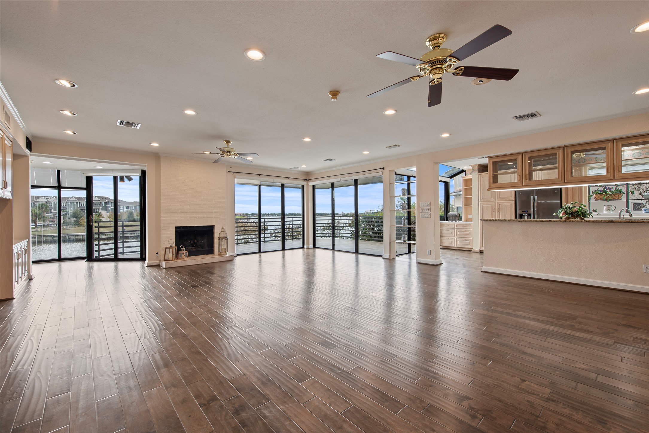 2037 Enterprise Avenue League City, TX 77573 - Photo 10 of 49 a view of an empty room with wooden floor and a kitchen