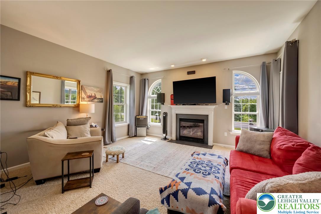 204 Bushkill Ridge Road Wind Gap, PA 18091 - Photo 13 of 48 An inviting family room offers a fireplace with mantel and ample natural light through large windows.