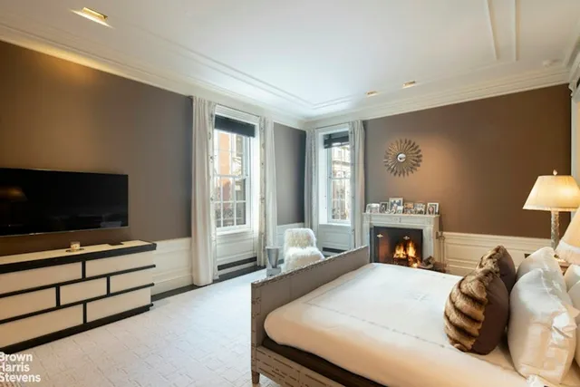 a bedroom with furniture and a fireplace