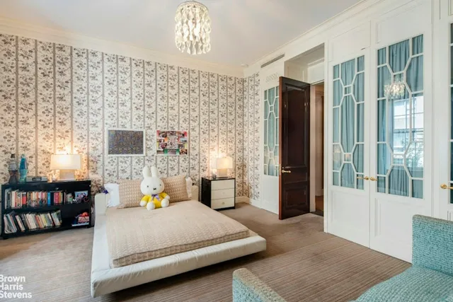 a bedroom with a bed couch and a window