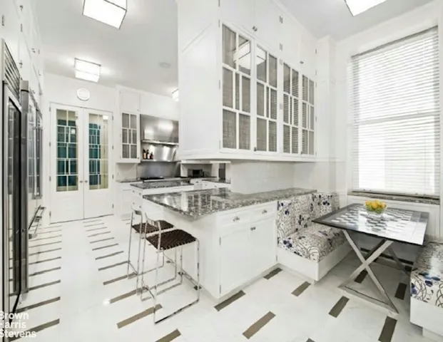 a kitchen with a sink cabinets and window