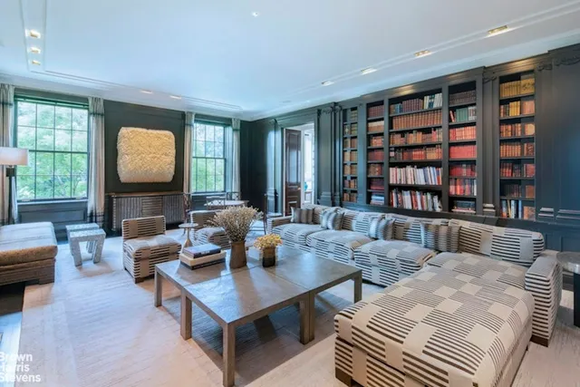 a living room with fireplace furniture and a book shelf