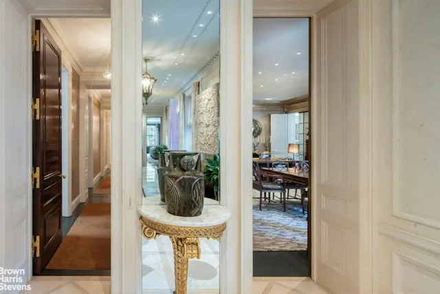 a view of a hallway with dining area and glass door